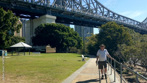 A middle aged male tourist sightseeing in Brisbane which is the capital of Queensland Australia.