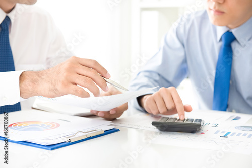 Businessmen analyzing financial documents