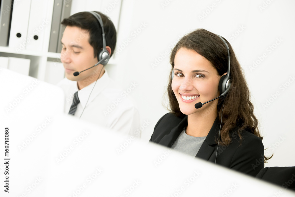 Young smiling beautiful woman working in call center Young smiling beautiful woman working in call center