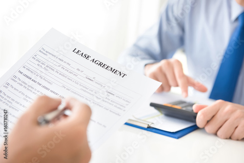 A man reading lease agreement paper