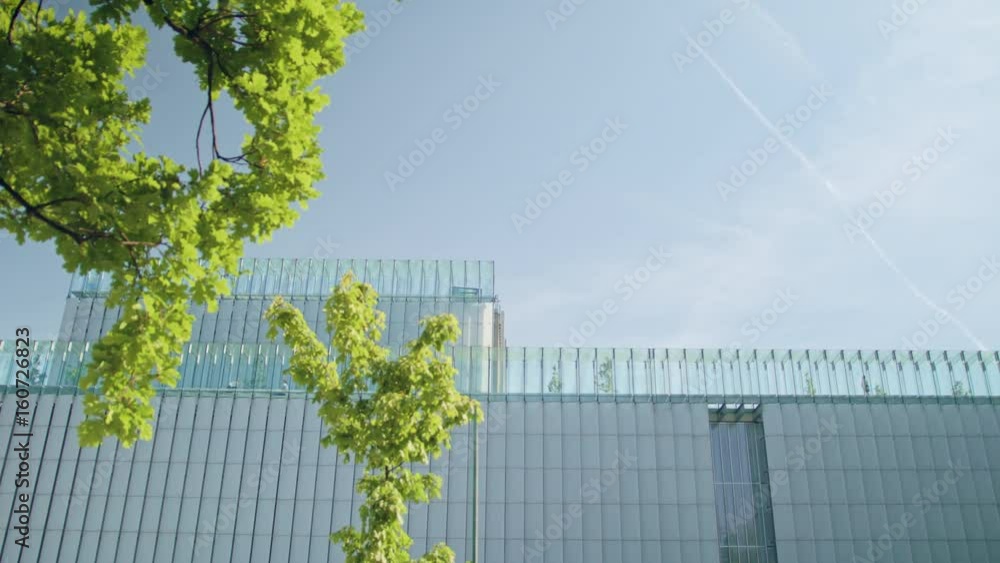 Top of a modern building against a clear sky background. View from below. Top of a modern building against a clear sky background. View from below.