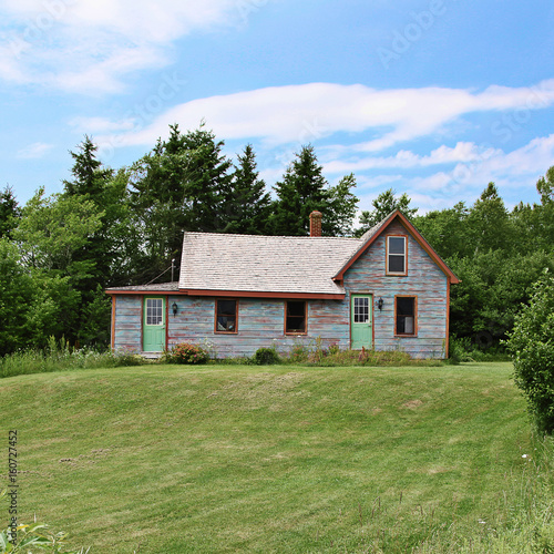 Old home with landscaped front yard in Summer