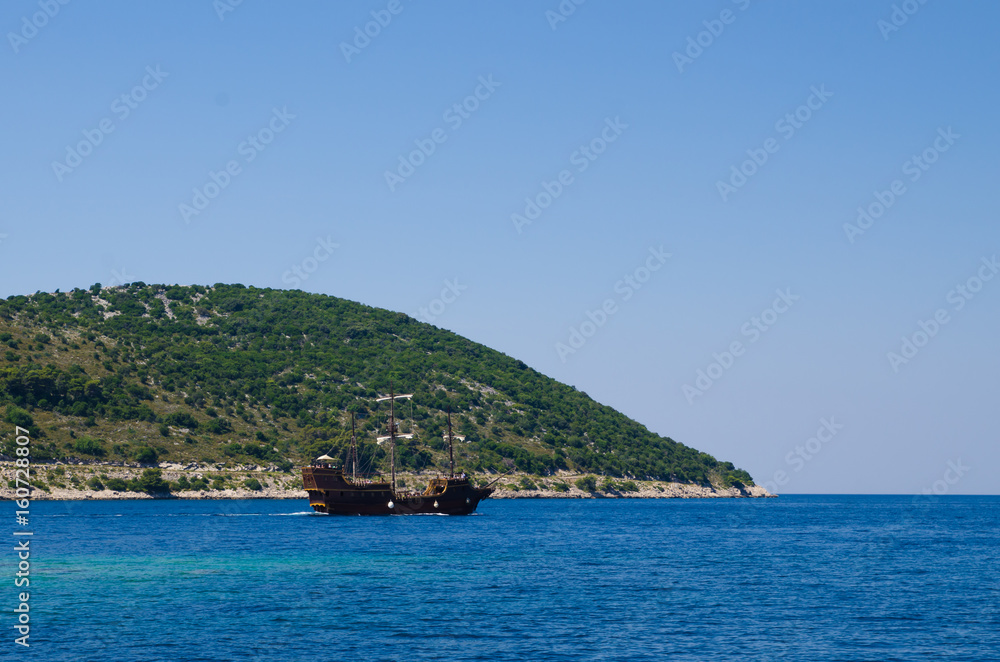 Wooden pirate ship sailing down the coast Wooden pirate ship sailing down the coast