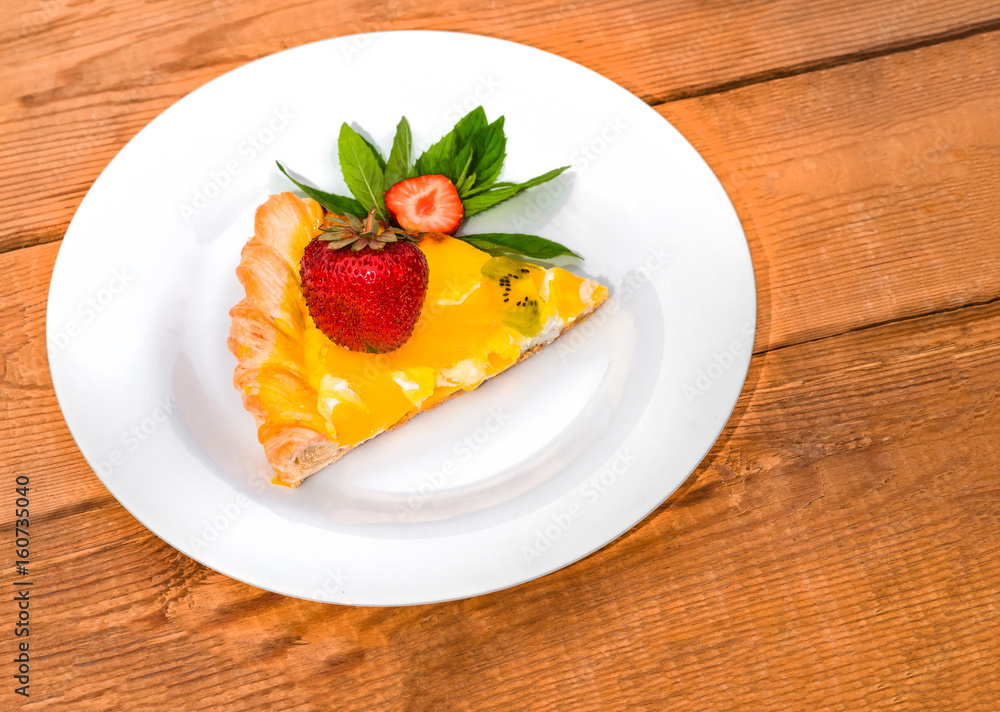 Slice of fruit pizza with strawberries and mint Slice of fruit pizza with strawberries and mint