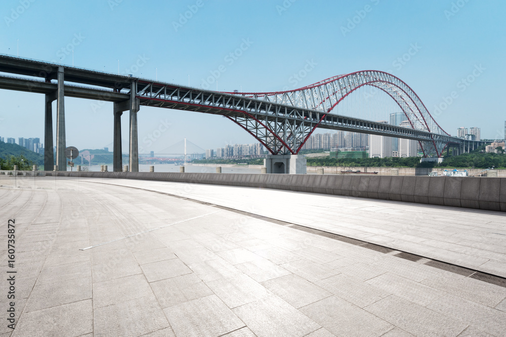 empty floor with steel bridge in modern city
