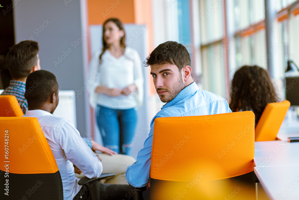Pretty young business woman giving a presentation in conference or meeting setting. Pretty young business woman giving a presentation in conference or meeting setting.