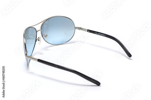 Sunglasses with blue glass in an iron frame isolated on white