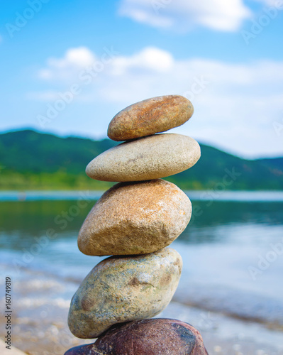 Photo of stones balanced on top of eachother on a beach