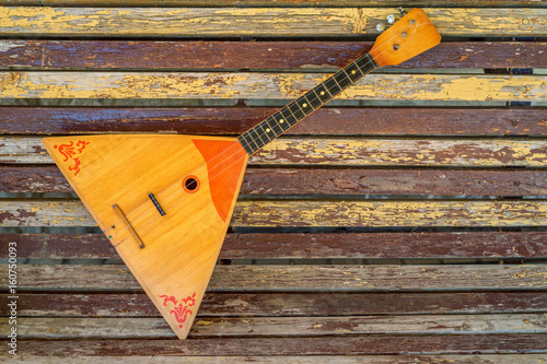 Musical instrument balalaika on wooden background photo