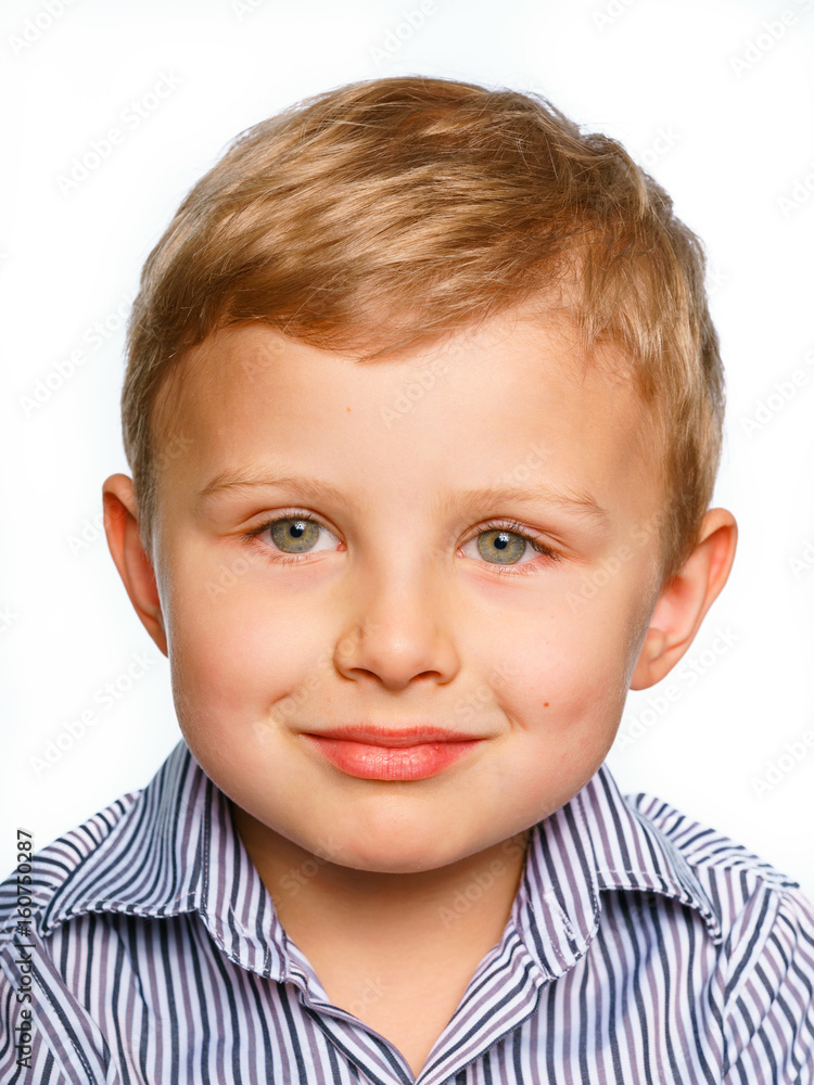 His first experience to make photo for passport or ID card. Emotionally grimacing little boy with blond hair and bright green eyes. White background. His first experience to make photo for passport or ID card. Emotionally grimacing little boy with blond hair and bright green eyes. White background.