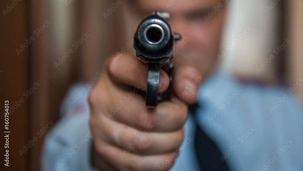 A hired assassin, a terrorist or a policeman in a black mask with a black combat gun A hired assassin, a terrorist or a policeman in a black mask with a black combat gun