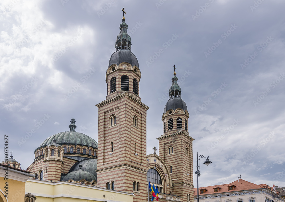 Detail of the Holy Trinity Metropolitan Cathedral in Sibiu, Romania, against a dramatic sky