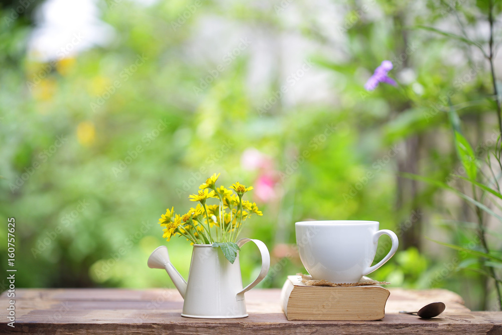 Notebook with yellow flower and cup on wooden table Notebook with yellow flower and cup on wooden table