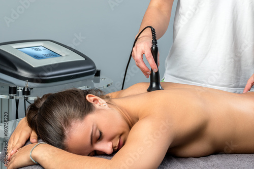 Young patient receiving interferential electrotherapy. photo