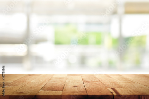 Wood table top on blur kitchen window background