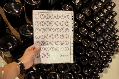 Making sparkling wine Champagne in winery. The traditional method of rotating the bottles every day by hand photo