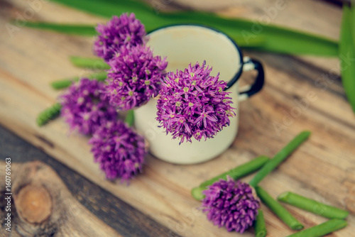 Allium flowers bouquet in a stylish metal decorative vase. Shallow depth of field