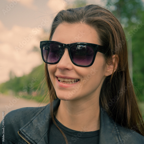 young woman in the sun wearing eyeglasses