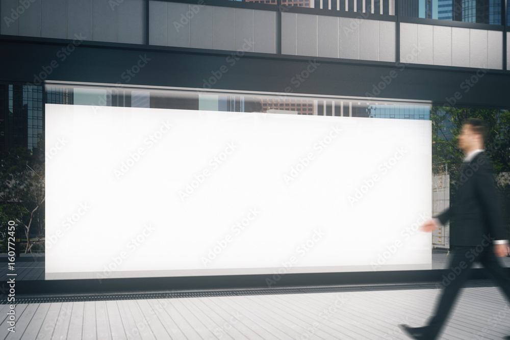 Businessman passing storefront Businessman passing storefront