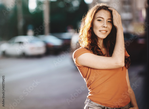 Summer outdoor porttrait of young pretty girl posing at sunset in city © Maksim Kostenko