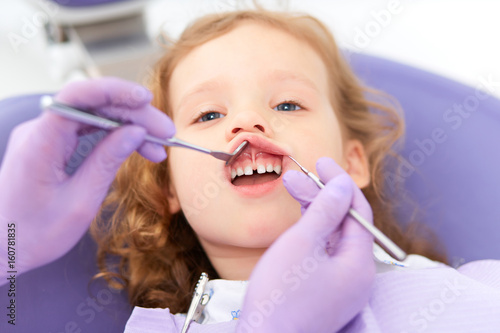 Dentist examining under lip