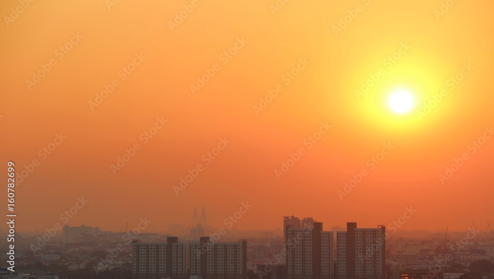 Fototapeta premium Blurred city / City is blurred by dust in the air under orange sky with big yellow sun