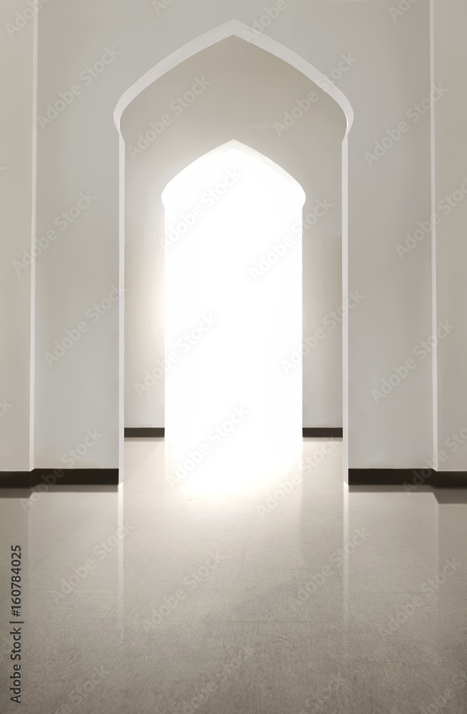 Portrait of arch door with tiled floor and white wal