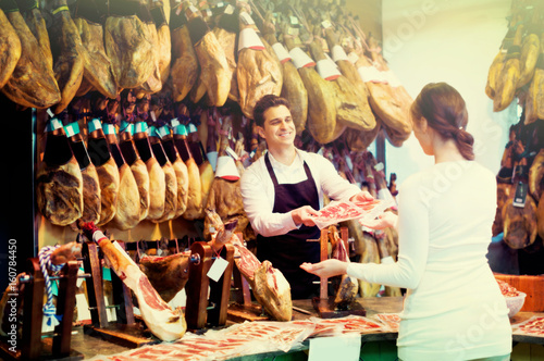 Female customer buying Spanish jamon