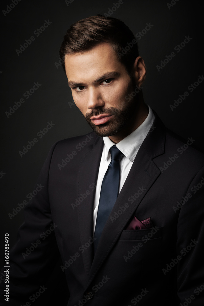 Handsome young businessman portrait on black background Handsome young businessman portrait on black background