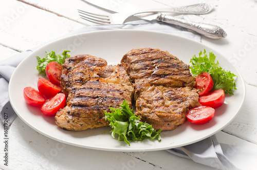 Grilled pork steak and vegetable salad