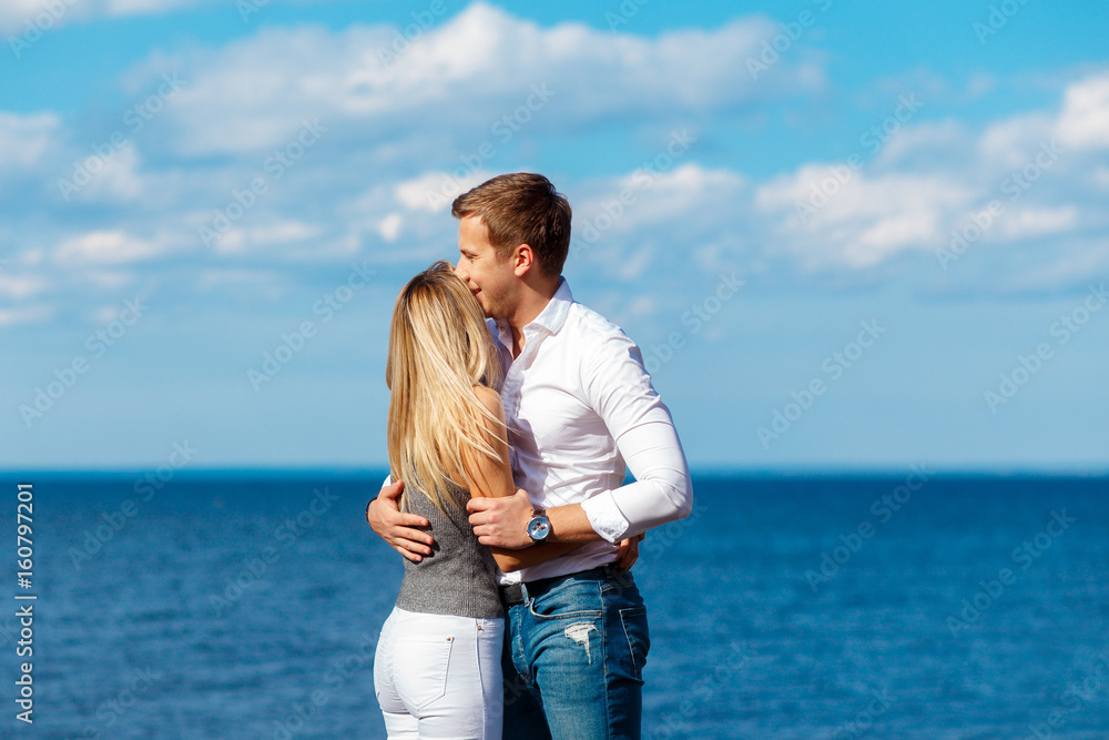Young couple enjoying themselves on a beach . Romantic couple in love