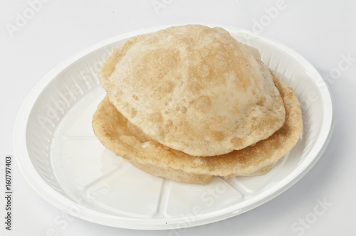 Puri on white disposable plate