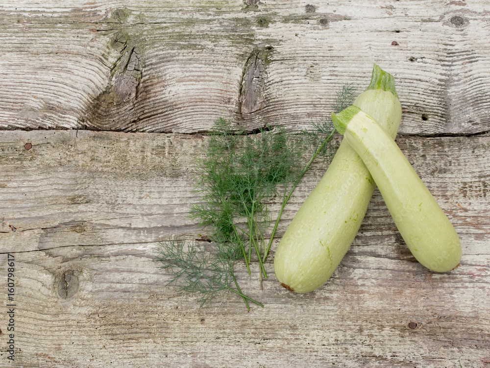Fresh organic zucchini on old wooden background Fresh organic zucchini on old wooden background