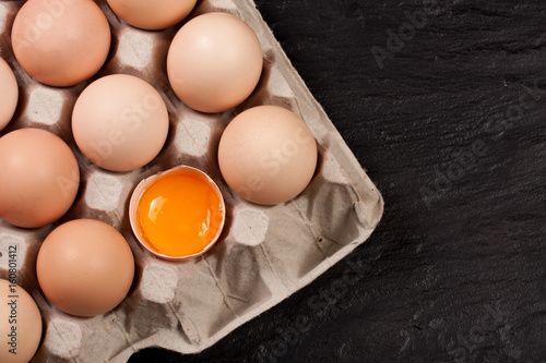 eggs in a tray on a dark background with copy space for your text. Top view