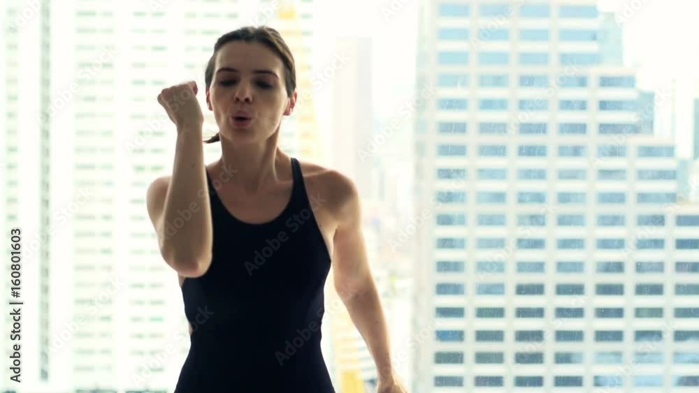 Young woman doing warmup, running by window in gym, super slow motion 240fps Young woman doing warmup, running by window in gym, super slow motion 240fps