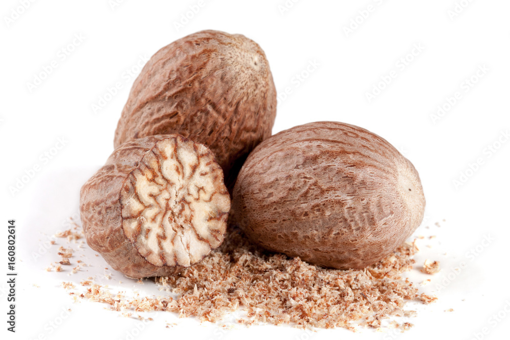 Three nutmeg and powder isolated on white background Three nutmeg and powder isolated on white background