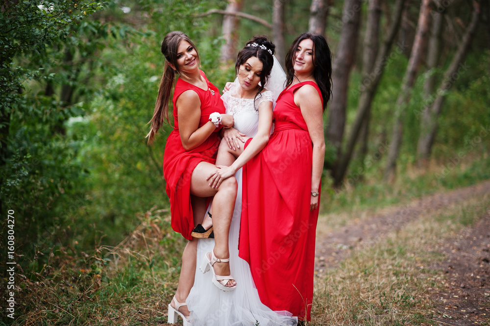 Fantastic bride with awesome bridesmaids having fun in the forest on a wedding day. Fantastic bride with awesome bridesmaids having fun in the forest on a wedding day.