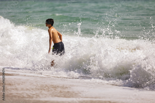 Beautiful young boy playing in the waves © czamfir