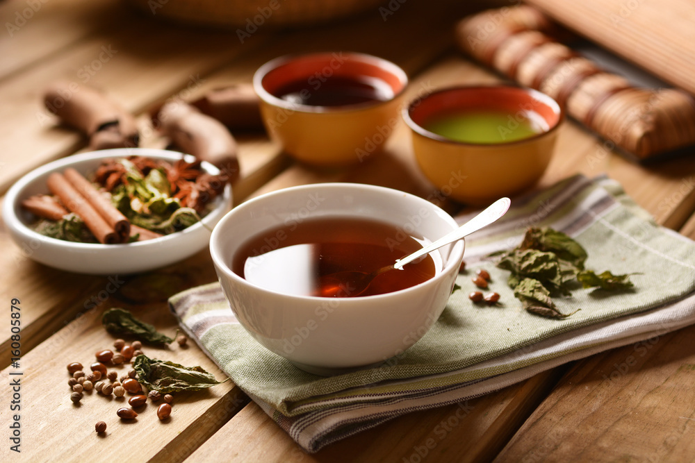 Fototapeta premium relaxing herbal tea in the bowl with ingredients around
