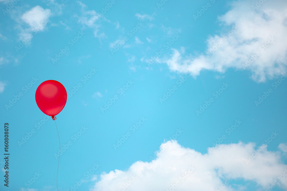 Red balloon on vintage sky