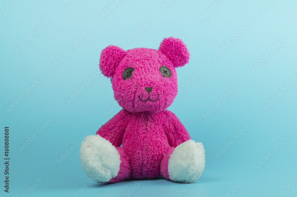 Obraz premium pink bear doll on blue background