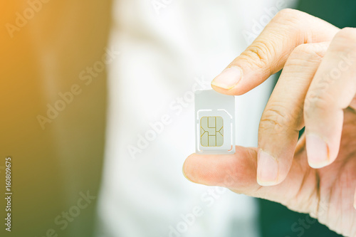 Plakat Hand holding sim card, select focus, color effect