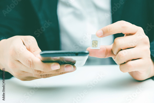 Plakat Hand holding sim card, select focus, color effect