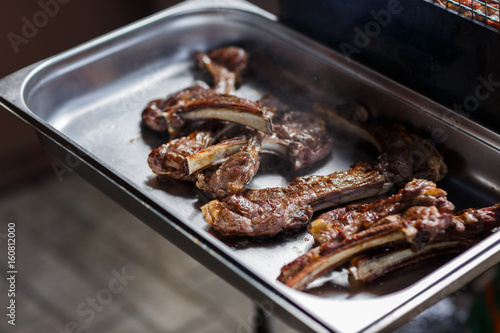 Fried meat on iron tray © snedorez