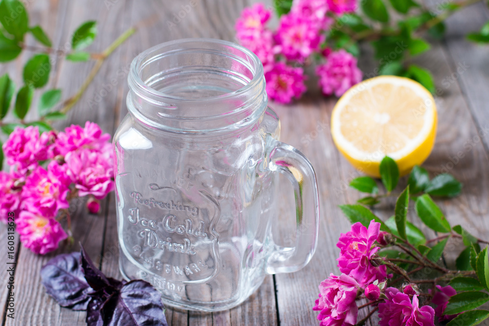 Glass jar for lemonade on a wooden background