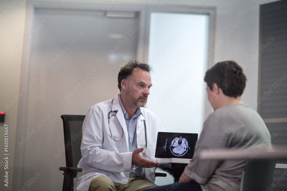 Male Medical Doctor explaining scan results to patient Male Medical Doctor explaining scan results to patient