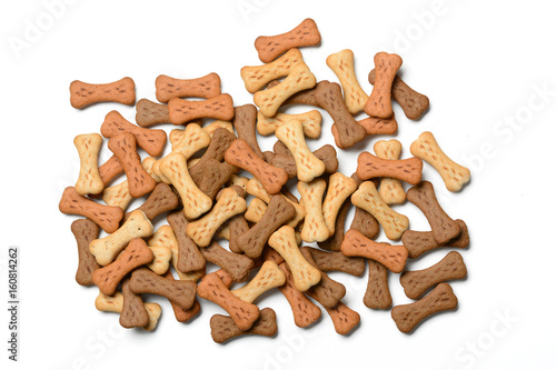 dog biscuits in the shape of bones in white background - closeup