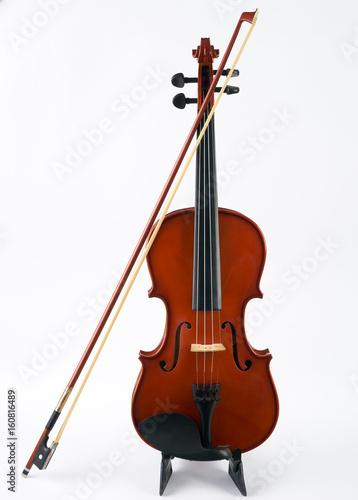 Violin with bow isolated on white background. Classical stringed musical instrument fiddle with fiddlestick.