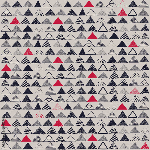 Vector seamless pattern. Hand drawn grayscale triangles with red patches.