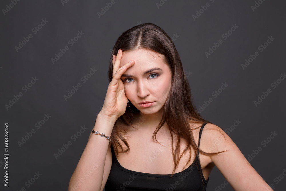 Portrait of young woman has headache Portrait of young woman has headache